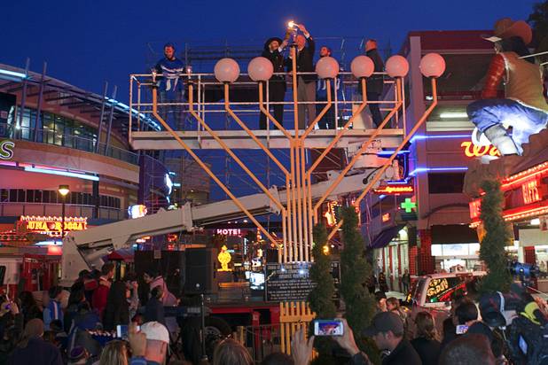 Rabbi Shea Harlig, center left, and Clark County District Attorney Steve Wolfson light a Hanukah menorah during a lightning ceremony at the Fremont Street Experience in downtown Las Vegas Sunday, Dec. 9, 2012.  Chabad of Southern Nevada sponsored the event. The Jewish holiday of Hanukah started Saturday evening and runs though Dec. 16.
