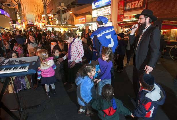 Rabbi Chaim Ozer Metal, right, sings during a Hanukah menorah lightning ceremony at the Fremont Street Experience in downtown Las Vegas Sunday, Dec. 9, 2012.  Chabad of Southern Nevada sponsored the event. The Jewish holiday of Hanukah started Saturday evening and runs though Dec. 16.