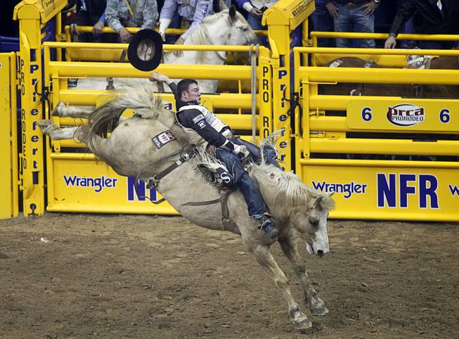 Steven Peebles of Redmond, Ore. rides Peaches and Cream to a 83 score in the bareback competition during the fourth go-round of the Wrangler National Finals Rodeo at the Thomas & Mack Center Sunday, Dec. 9, 2012. The NFR continues through Saturday.