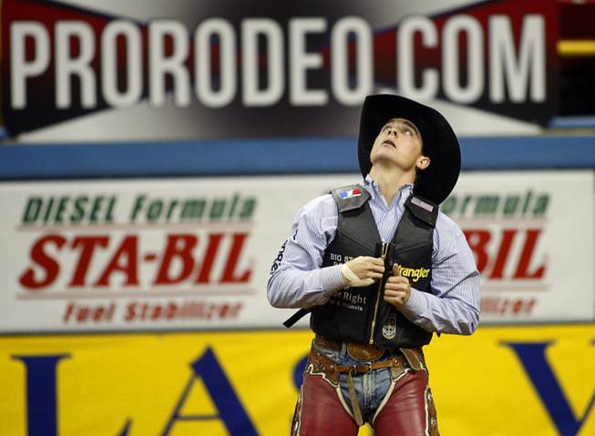 Saddle Bronc rider Jesse Wright of Milford, Utah looks to the scoreboard after riding to a 90 score, the best of the night, during the fourth go-round of the Wrangler National Finals Rodeo at the Thomas & Mack Center Sunday, Dec. 9, 2012. The NFR continues through Saturday.