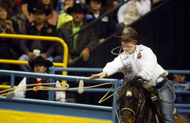 Tie-down roper Tuf Cooper competes during the fourth go-round of the Wrangler National Finals Rodeo at the Thomas & Mack Center Sunday, Dec. 9, 2012. Cooper tied his calf in just 7.8 seconds, the best time of the night. The NFR continues through Saturday.