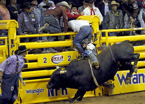 Bull rider Clayton Savage of Casper, Wyo. competes during the fourth go-round of the Wrangler National Finals Rodeo at the Thomas & Mack Center Sunday, Dec. 9, 2012. The NFR continues through Saturday.
