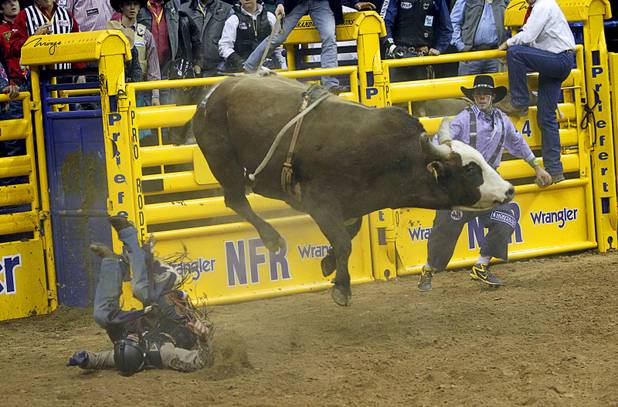 Bull rider Cody Whitney of Sayre, Okla. is thrown from his bull during the fourth go-round of the Wrangler National Finals Rodeo at the Thomas & Mack Center Sunday, Dec. 9, 2012. The NFR continues through Saturday.