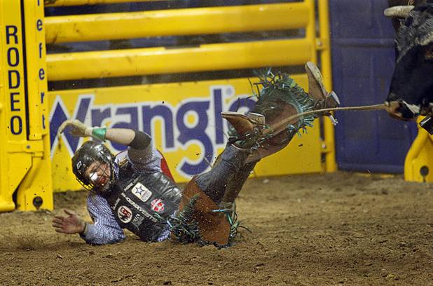 Bull rider Seth Glause of Cheyenne, Wyo. hits the ground after being thrown from his bull during the fourth go-round of the Wrangler National Finals Rodeo at the Thomas & Mack Center Sunday, Dec. 9, 2012. The NFR continues through Saturday.