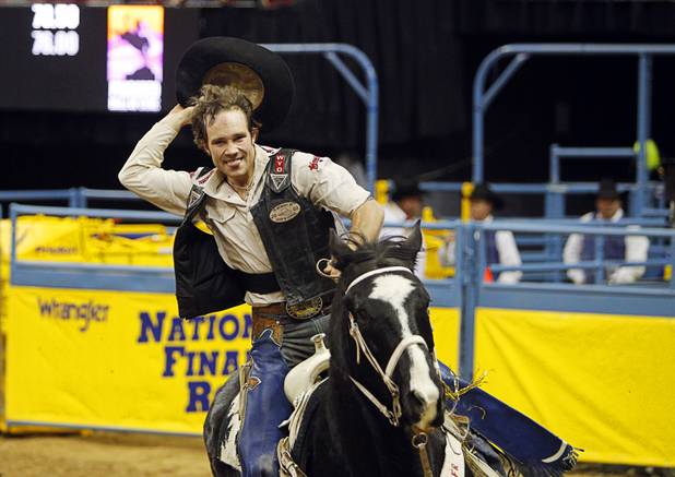 Bull rider Clayton Savage of Casper, Wyo. takes a lap around the arena after making the high score of the night during the fourth go-round of the Wrangler National Finals Rodeo at the Thomas & Mack Center Sunday, Dec. 9, 2012. The NFR continues through Saturday.