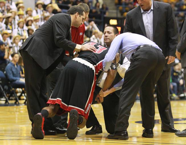 UNLV forward Mike Moser's elbow is stabilized as he is helped up during the first half of their game against Cal Sunday, Dec. 9, 2012 at Haas Pavilion in Berkeley, Calif. UNLV won 76-75. Moser came out of the game with a dislocated elbow.