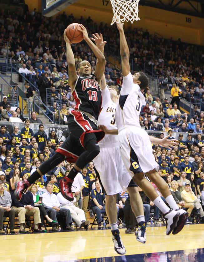 UNLV guard Bryce Dejean-Jones slices to the basket while being defended by Cal forward Robert Thurman and guard Tyrone Wallace, right, during the first half of their game Sunday, Dec. 9, 2012 at Haas Pavilion in Berkeley, Calif. UNLV won 76-75.