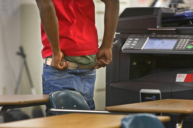 A student pulls up his sagging pants during an English ...
