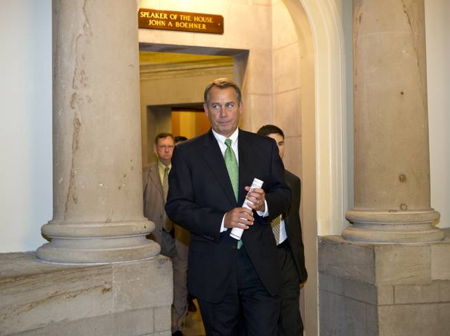 House Speaker John Boehner of Ohio leaves his office and walks to the House floor to deliver remarks about negotiations with President Obama on the fiscal cliff, Tuesday, Dec. 11, 2012, on Capitol Hill in Washington.