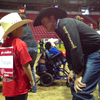 Trevor Brazile, who clinched his 10th Professional Rodeo Cowboys Association world champ title on Monday night, helps out at the Exceptional Rodeo earlier in the day at the Thomas & Mack Center in Las Vegas. 
