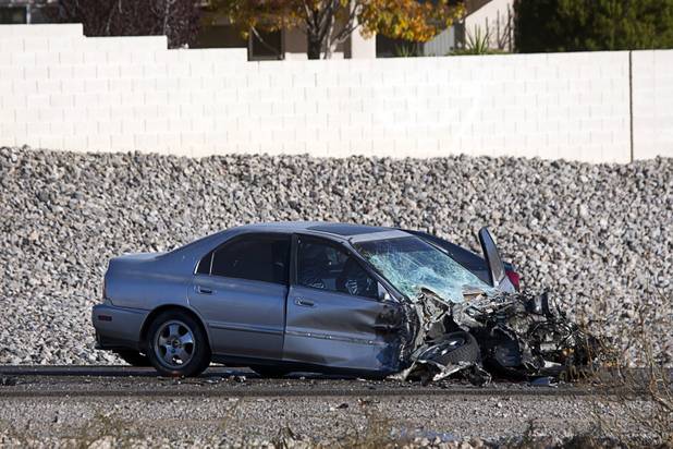 A Honda Accord is shown after an accident with a Clark County School District school bus on Summerlin Parkway westbound near Anasazi Drive Wednesday, Dec. 12, 2012. The Honda was heading eastbound on the parkway when the driver crossed the median and into oncoming traffic, colliding with the bus, Nevada Highway Patrol troopers said.