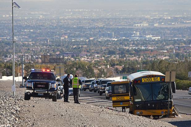 Nevada Highway Patrol troopers investigate an accident involving a Clark County School District school bus and a Honda Accord on Summerlin Parkway westbound near Anasazi Drive Wednesday, Dec. 12, 2012. The Honda was heading eastbound on the parkway when the driver crossed the median and into oncoming traffic, colliding with the bus, troopers said.