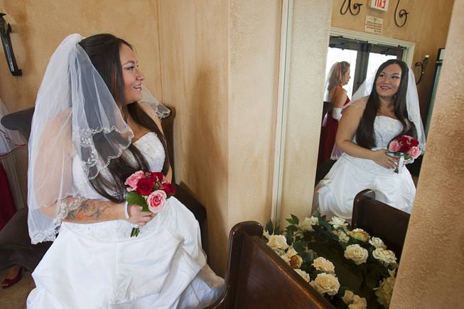 Danielle Martinez looks at her reflection before a group wedding at the Chapel of the Flowers on Las Vegas Boulevard South Wednesday, Dec. 12, 2012. Twelve couples got married at 12:12 pm at the chapel as part of a KOMP 92.3 radio station promotion. Las Vegas wedding chapels were busy all day as many couples wanted to get married on the date of 12-12-12.