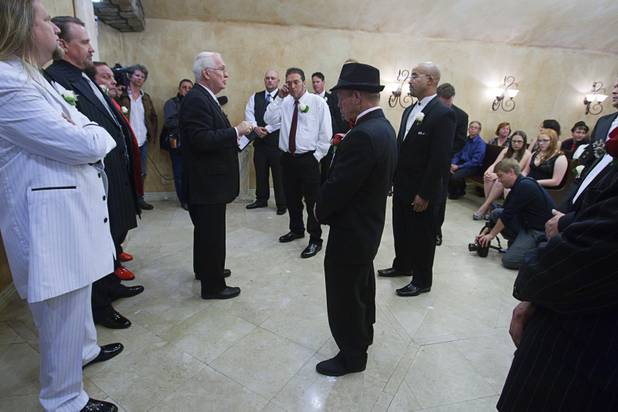 Minister Al Hansen talks with grooms before a group wedding at the Chapel of the Flowers on Las Vegas Boulevard South Wednesday, Dec. 12, 2012. Twelve couples got married at 12:12 pm at the chapel as part of a KOMP 92.3 radio station promotion. Las Vegas wedding chapels were busy all day as many couples wanted to get married on the date of 12-12-12.