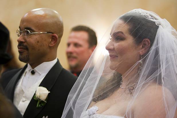 Leon Ennis and Christina Kleven take part in a group wedding at the Chapel of the Flowers on Las Vegas Boulevard South Wednesday, Dec. 12, 2012. Twelve couples got married at 12:12 pm at the chapel as part of a KOMP 92.3 radio station promotion. Las Vegas wedding chapels were busy all day as many couples wanted to get married on the date of 12-12-12.