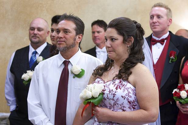 Ed Arrey and Tracy Mauro take part in a group wedding at the Chapel of the Flowers on Las Vegas Boulevard South Wednesday, Dec. 12, 2012. Twelve couples got married at 12:12 pm at the chapel as part of a KOMP 92.3 radio station promotion. Las Vegas wedding chapels were busy all day as many couples wanted to get married on the date of 12-12-12.