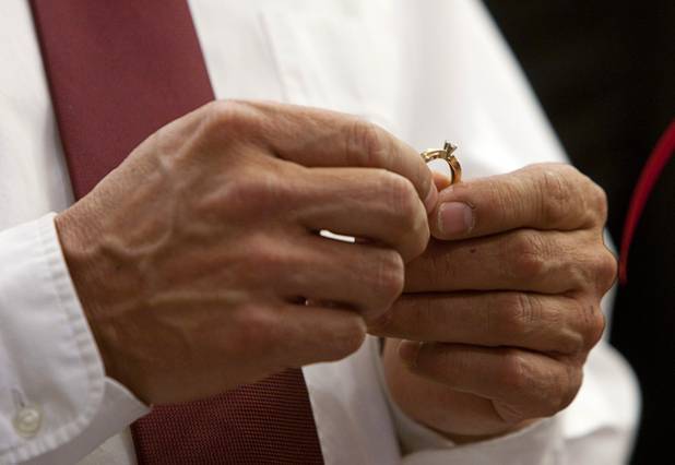 Ed Arrey holds a ring as he gets married to Tracy Mauro during a group wedding at the Chapel of the Flowers on Las Vegas Boulevard South Wednesday, Dec. 12, 2012. Twelve couples got married at 12:12 pm at the chapel as part of a KOMP 92.3 radio station promotion. Las Vegas wedding chapels were busy all day as many couples wanted to get married on the date of 12-12-12.