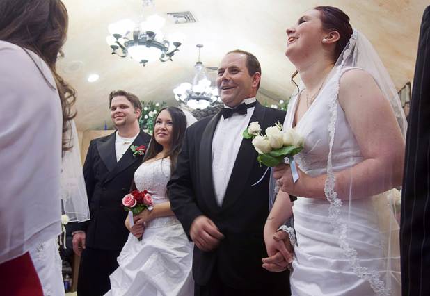 From left, Ryan Maluka, Danielle Martinez, Christopher Shultz and Jessica Cook take part in a group wedding at the Chapel of the Flowers on Las Vegas Boulevard South Wednesday, Dec. 12, 2012. Twelve couples got married at 12:12 pm at the chapel as part of a KOMP 92.3 radio station promotion. Las Vegas wedding chapels were busy all day as many couples wanted to get married on the date of 12-12-12.