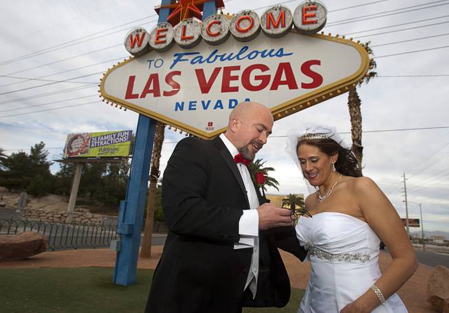 Randy Anderson and Jenni Lafollette of Minneapolis, Minn. look at a photo on their digital camera after getting married Wednesday, Dec. 12, 2012. Las Vegas wedding chapels were busy all day as many couples wanted to get married on the date of 12-12-12.