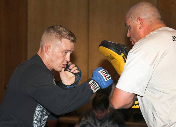 Welterweight fighter Colton Smith, left, works on his timing with Jason Schaefer during UFC Ultimate Fighter Finale workouts at the Hard Rock Thursday, Dec. 13, 2012.