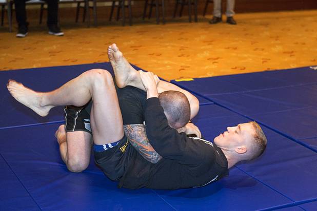 Welterweight fighter Colton Smith, right, grapples with Jarrod Clontz during UFC Ultimate Fighter Finale workouts at the Hard Rock Thursday, Dec. 13, 2012.