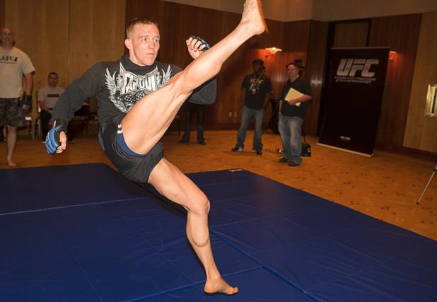 Welterweight fighter Colton Smith, right, practices a kick during UFC Ultimate Fighter Finale workouts at the Hard Rock Thursday, Dec. 13, 2012.
