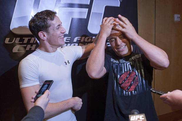 Welterweight fighter Mike Ricci, left, rubs the head of Pat Barry as Barry makes an impersonation of Ricci during UFC Ultimate Fighter Finale workouts at the Hard Rock Thursday, Dec. 13, 2012.