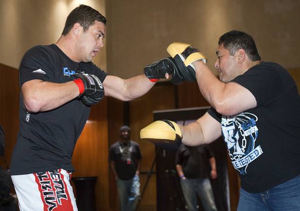 Heavyweight fighter Shane Del Rosario, left, works on his timing with Colin Oyama during UFC Ultimate Fighter Finale workouts at the Hard Rock Thursday, Dec. 13, 2012.