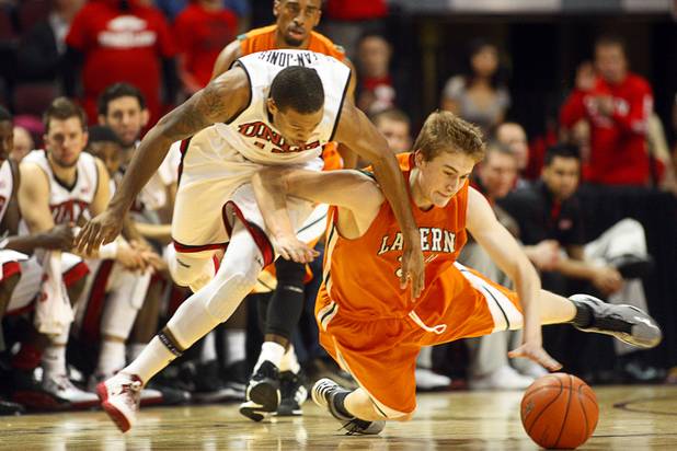 UNLV's Bryce Dejean-Jones and Paul Titchener scramble for a loose ball during their game against the La Verne Leopards at the Orleans Arena Thursday, Dec. 13, 2012.