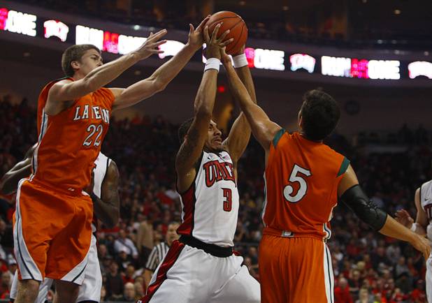UNLV's Anthony Marshal pulls down an offensive rebound against La Verne's Vince Bauer, left, and Jourdan Simmonds during their game against the La Verne Leopards at the Orleans Arena Thursday, Dec. 13, 2012.