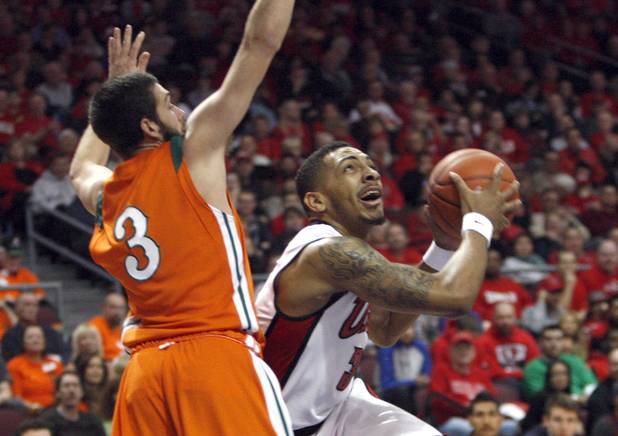 UNLV' s Anthony Marshall, right, drives to the basket against Ron See during UNLV's game against the La Verne Leopards at the Orleans Arena Thursday, Dec. 13, 2012.