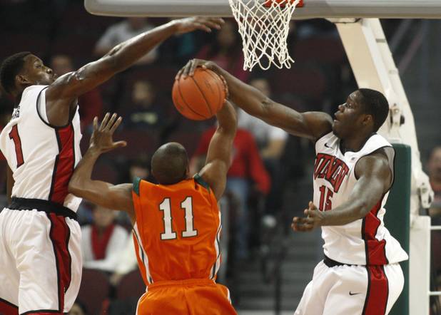 UNLV's Quintrell Thomas, left, and Anthony Bennett shut down Alonzo Young during UNLV's game against the La Verne Leopards at the Orleans Arena Thursday, Dec. 13, 2012.