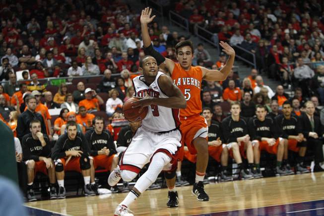 UNLV's Anthony Marshall drives to the basket during UNLV's game against the La Verne Leopards at the Orleans Arena Thursday, Dec. 13, 2012. La Verne's Jourdan Simmonds is at right.