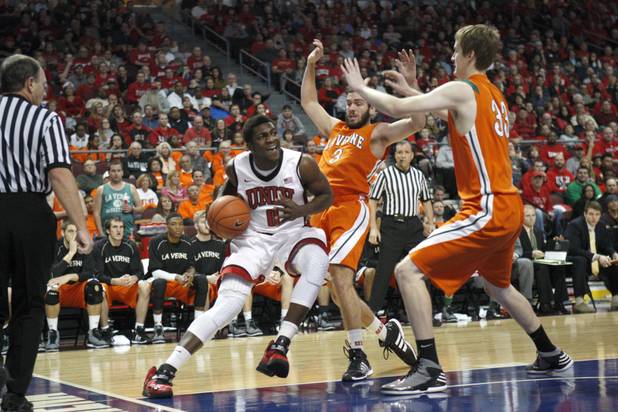 UNLV's Savon Goodman drives to the basket against Ron See, center, and Paul Titchener during UNLV's game against the La Verne Leopards at the Orleans Arena Thursday, Dec. 13, 2012.