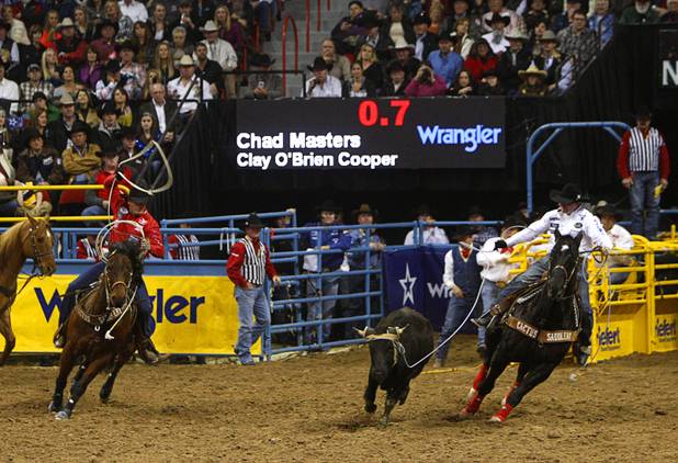 Team ropers Clay O'Brian Cooper, left, of Gardnerville, Nev. and Chad Masters of Cedar Hill, Tenn. compete during the final night of the Wrangler National Finals Rodeo Saturday, Dec. 15, 2012. Team ropers split the world championship with header Chad Masters and heeler Jade Corkill of Fallon, Nev. winning championships.