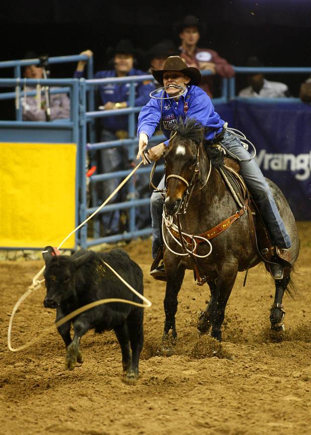 Tie-down roper Tuf Cooper of Decatur, Texas ropes his calf during the final night of the Wrangler National Finals Rodeo Saturday, Dec. 15, 2012. Cooper won the championship in tie-down roping.