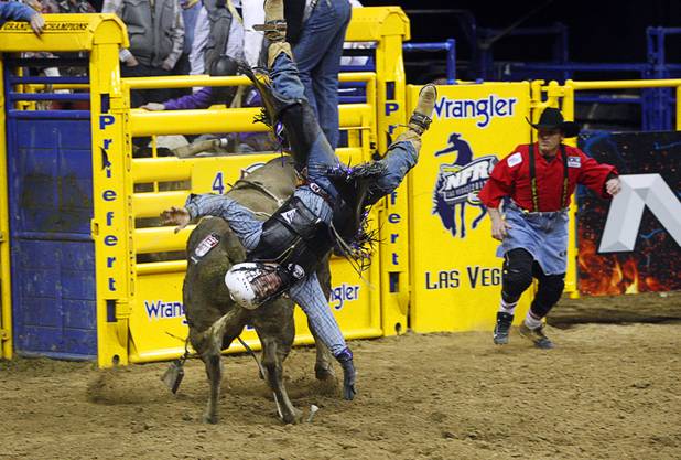 Trey Benton III of Rock, Island, Texas is thrown from a bull during the final night of the Wrangler National Finals Rodeo Saturday, Dec. 15, 2012.