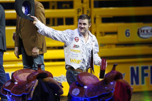 Bareback rider Kaycee Feild of Payson, Utah is introduced after winning the world title during the final night of the Wrangler National Finals Rodeo Saturday, Dec. 15, 2012.