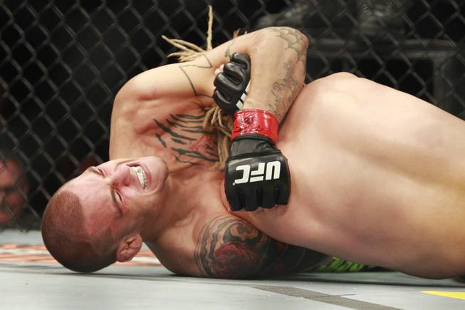 Dustin Poirier submits Jonathan Brookins with a choke during their bout at "The Ultimate Fighter 16" Saturday, Dec. 15, 2012, at the Joint in the Hard Rock Hotel.