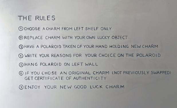 Rules are posted on the wall at the Ellen Harvey Exhibit at the P3 Studio in the Cosmopolitan Monday, Dec. 17, 2012. "Exchange Your Luck" allows guests to swap ineffective lucky charms for new ones.  Two adjacent shelves in P3Studio will hold two sets of 77 different small bronze lucky charms by Ellen Harvey.  Each charm will be an edition of only two. One set of charms will stay in P3Studio for the duration of the residency, while the other set is available for guests to take provided they leave their own lucky charm in exchange. The object for which the charm is swapped will be photographed and its Polaroid installed on the wall.