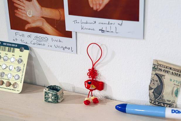 Items are displayed on an exchange wall at the Ellen Harvey Exhibit at the P3 Studio in the Cosmopolitan Monday, Dec. 17, 2012. "Exchange Your Luck" allows guests to swap ineffective lucky charms for new ones.  Two adjacent shelves in P3Studio will hold two sets of 77 different small bronze lucky charms by Ellen Harvey.  Each charm will be an edition of only two. One set of charms will stay in P3Studio for the duration of the residency, while the other set is available for guests to take provided they leave their own lucky charm in exchange. The object for which the charm is swapped will be photographed and its Polaroid installed on the wall.