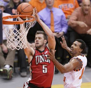 UNLV's Katin Reinhardt lays up a shot past Texas-El Paso's Jacques Streeter during a game Monday, Dec. 17, 2012, in El Paso, Texas. 