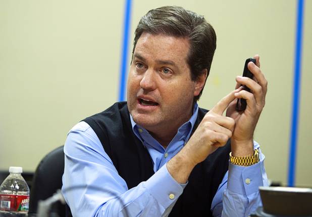 Mark James, president/CEO of Frias Transportation Infrastructure (FTi), points to his smartphone as he describes FTi software Tuesday, Dec. 18, 2012. The GPS-based system would provide useful real-time information to both regulators and consumers.