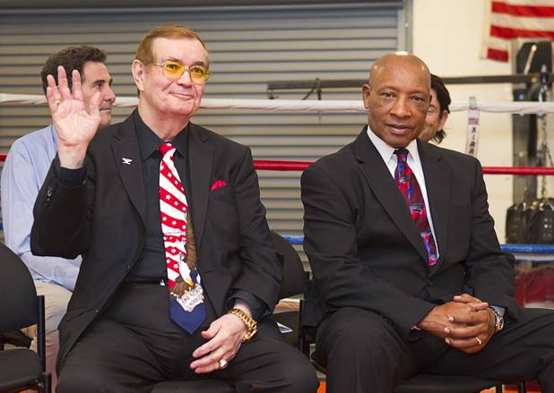 "Colonel" Bob Sheridan, left, boxing commentator and judge, waves as he is introduced during a Nevada Boxing Hall of Fame (NVBHOF) news conference at the Richard Steele Boxing Club in North Las Vegas Wednesday, Dec. 19, 2012. At right is former boxing referee Richard Steele. Induction will take place in 2013.