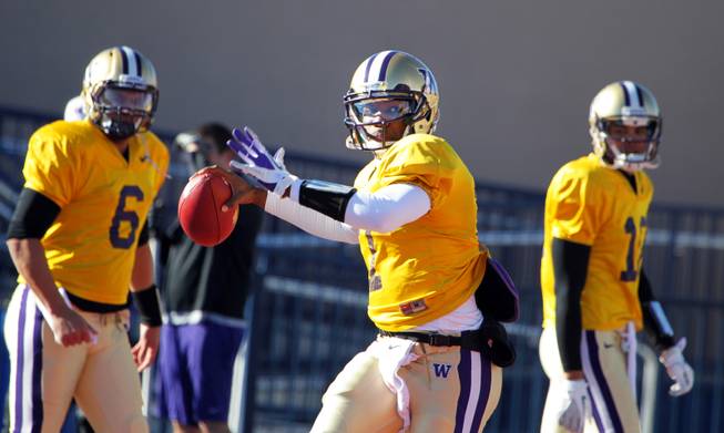 Washington quarterback Keith Price practices with his team at Bishop Gorman High School in Las Vegas on Wednesday, December 19, 2012. Washington is preparing to face Boise State in Saturday's Maaco Bowl Las Vegas