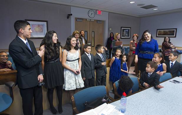 Members of the Maciel family assemble in family court Thursday, Dec. 20, 2012. The family officially adopted four more children for a total of eleven children. The father is not pictured due to his position as a state investigator.