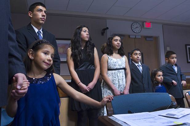 Members of the Maciel family listen to proceedings at family court Thursday, Dec. 20, 2012. The family officially adopted four more children for a total of eleven children.
