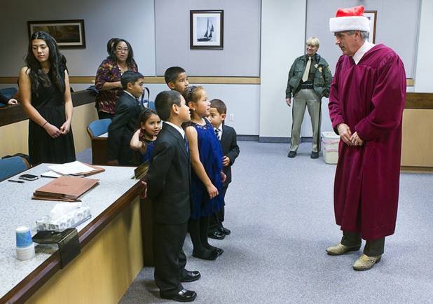 Maciel children meet Judge Frank Sullivan after an official adoption proceeding at family court Thursday, Dec. 20, 2012. The family officially adopted four more children for a total of eleven children.