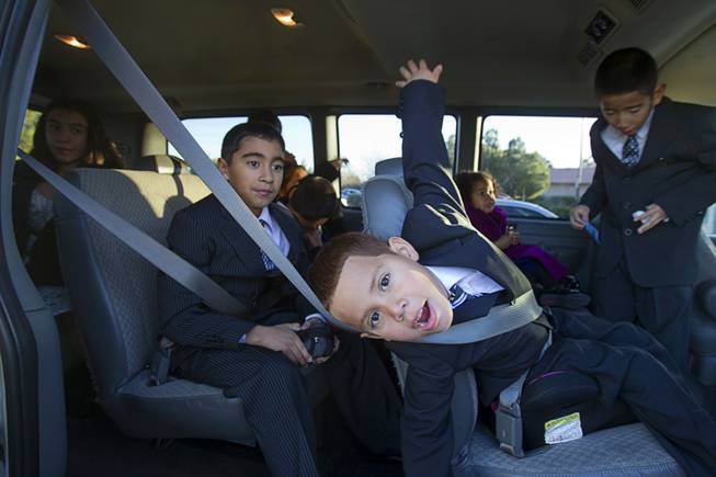 The Maciel family buckler up in their 12-passenger van after an adoption proceeding at family court Thursday, Dec. 20, 2012. The family officially adopted four more children, including Joey, 5, center, for a total of eleven children.
