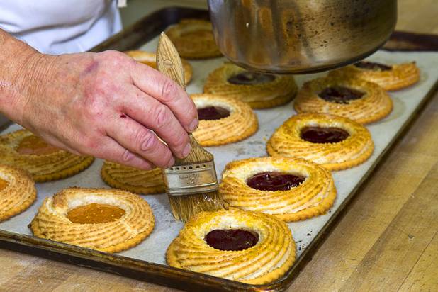 Chef Flemming Pedersen glazes pastries at Chef Flemmings Bake Shop, a European-style bakery, on Water Street in downtown Henderson Thursday, Dec. 20, 2012.